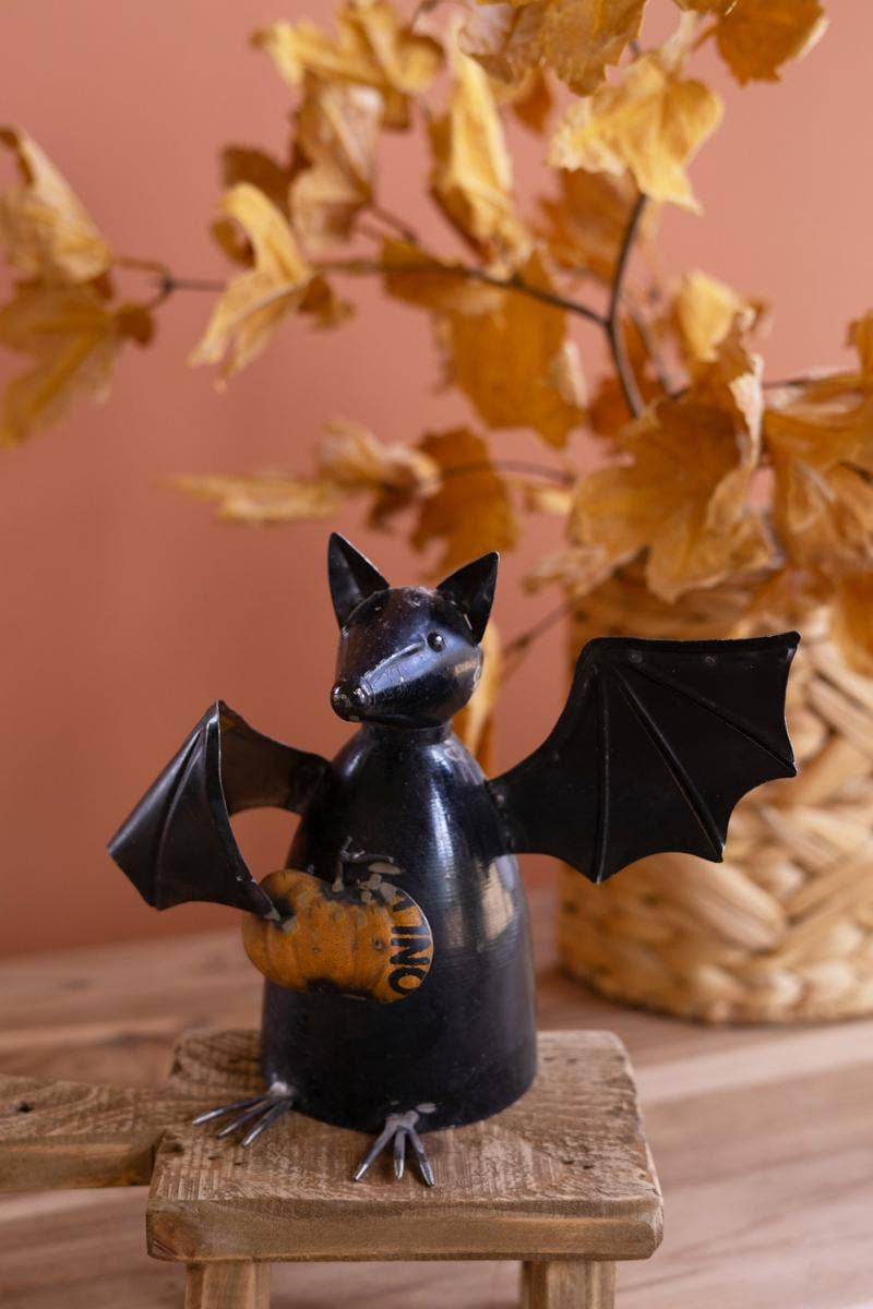 RECYCLED METAL BAT HOLDING A PUMPKIN